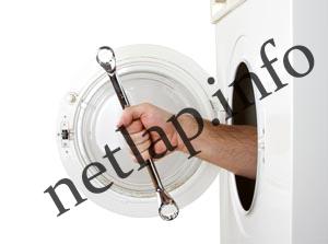 Repairman servicing washing machine